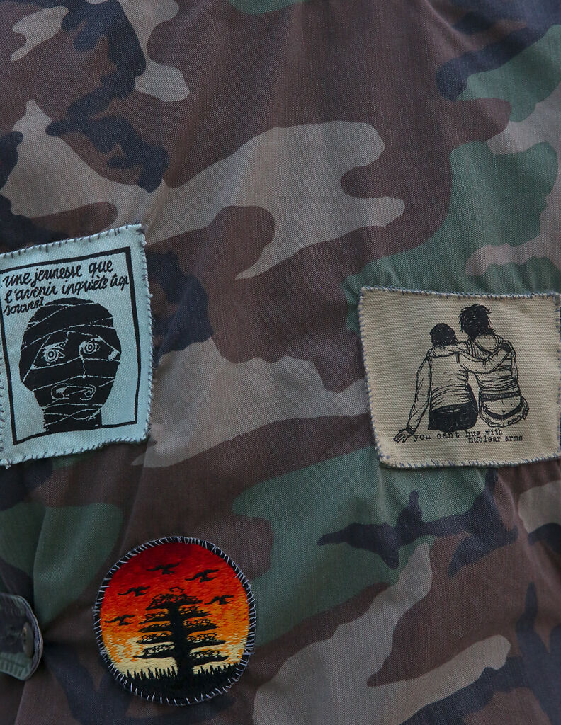 Patches are stitched on the back of Erica Ascani's jacket on Wednesday at the intersection of Broadway Blvd. and Providence Rd.